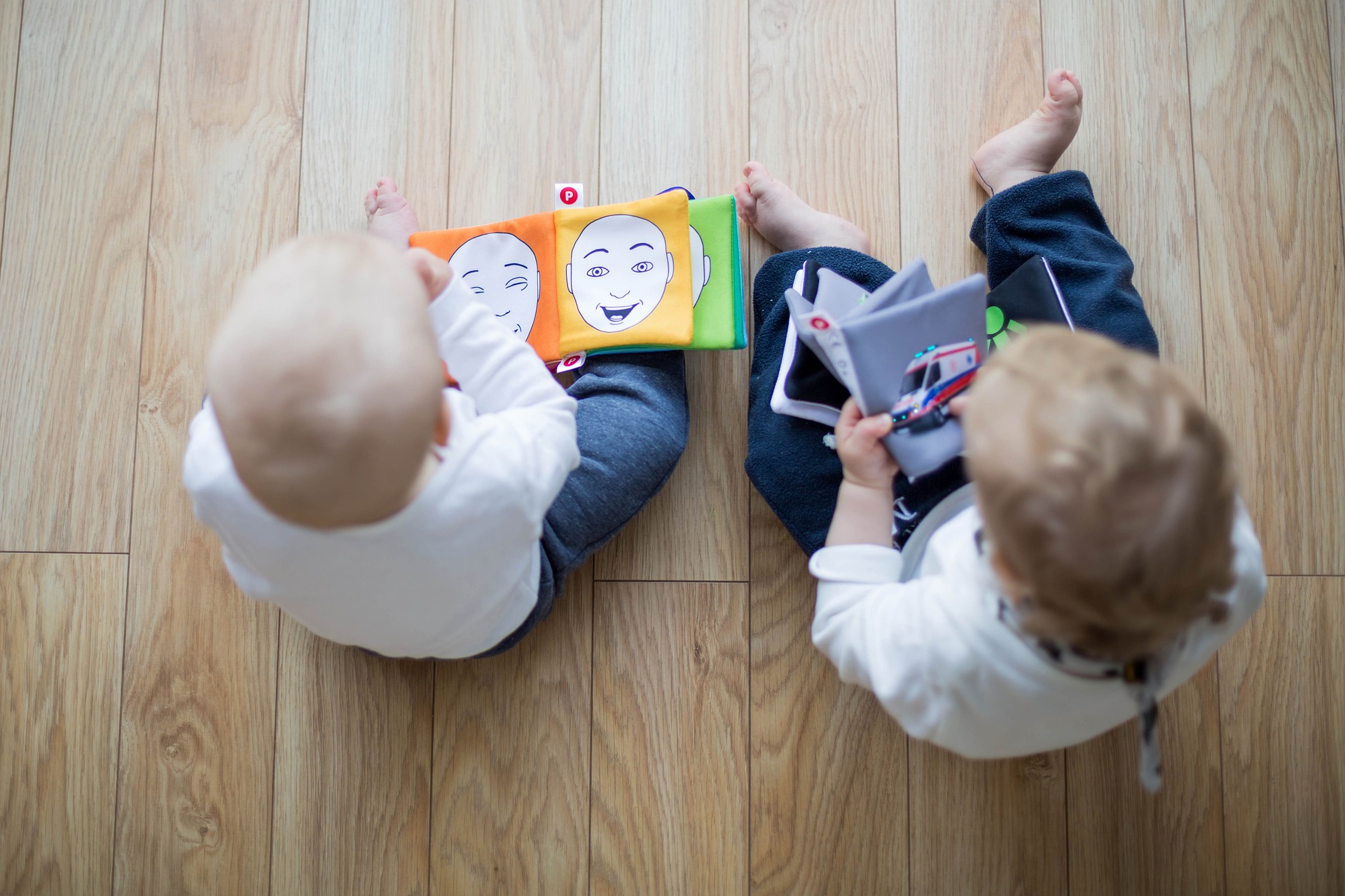 two babies reading books