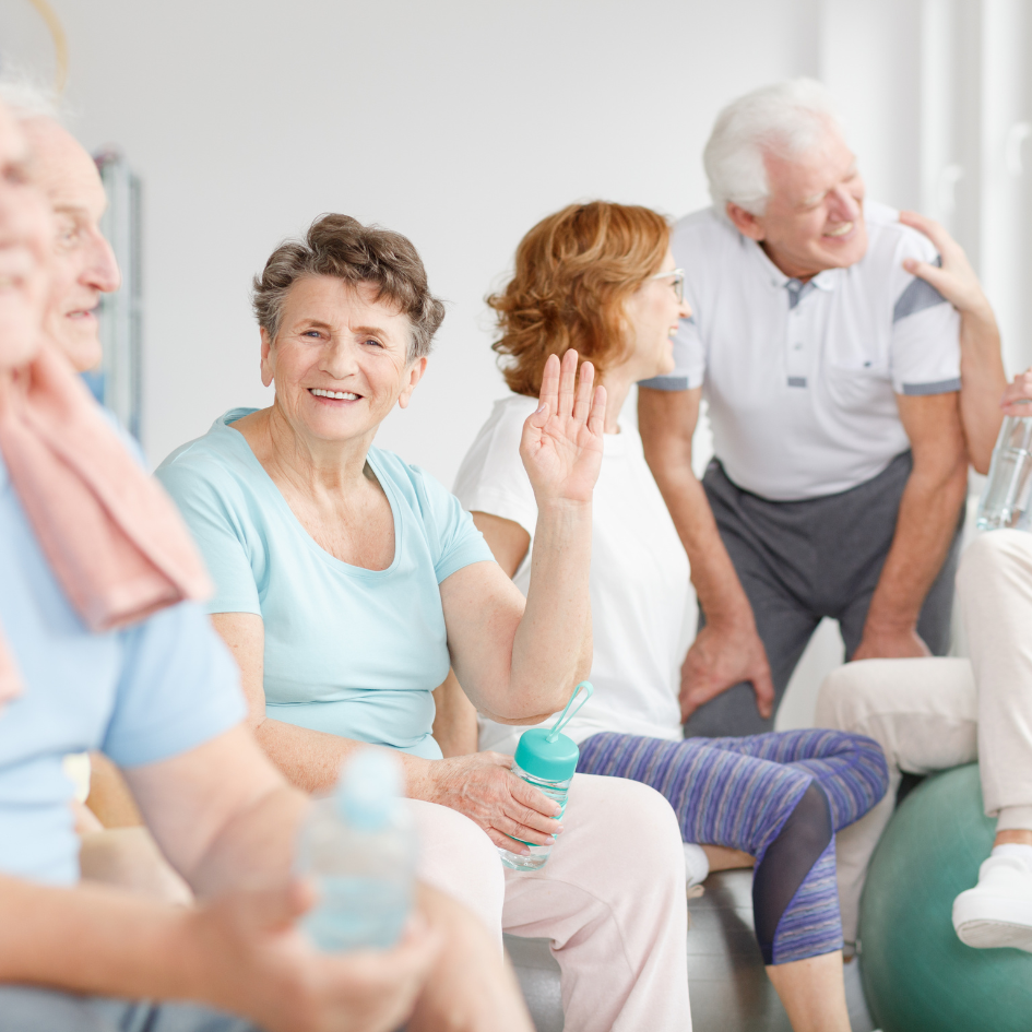 Smiling older adults socializing and exercising.