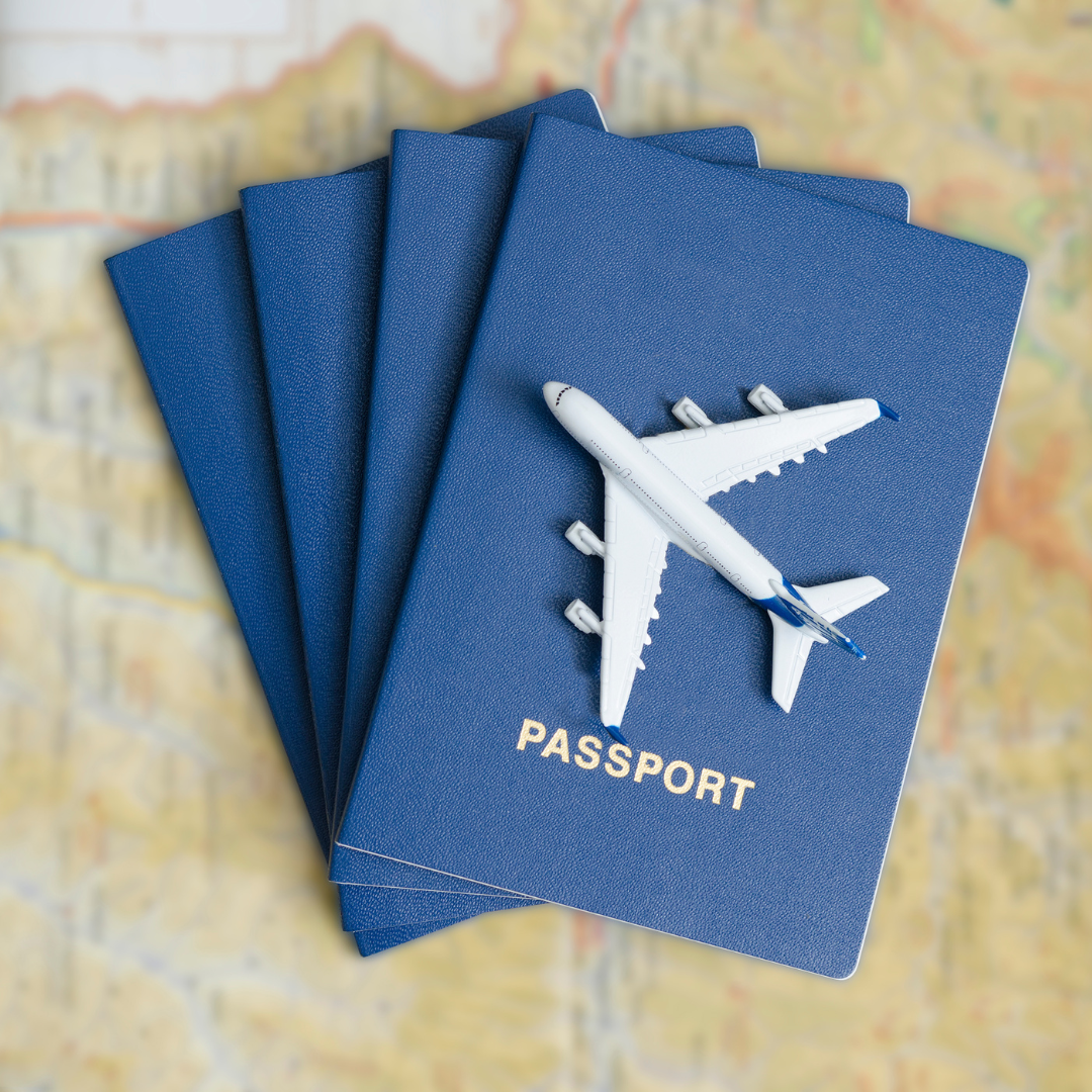 passport booklets on a map with a toy airplane