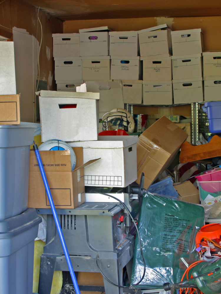 Cluttered storage area filled with boxes and belongings.