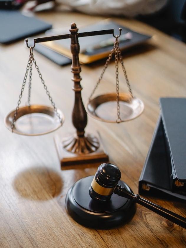 photo of a desk with scales of justice and a gavel