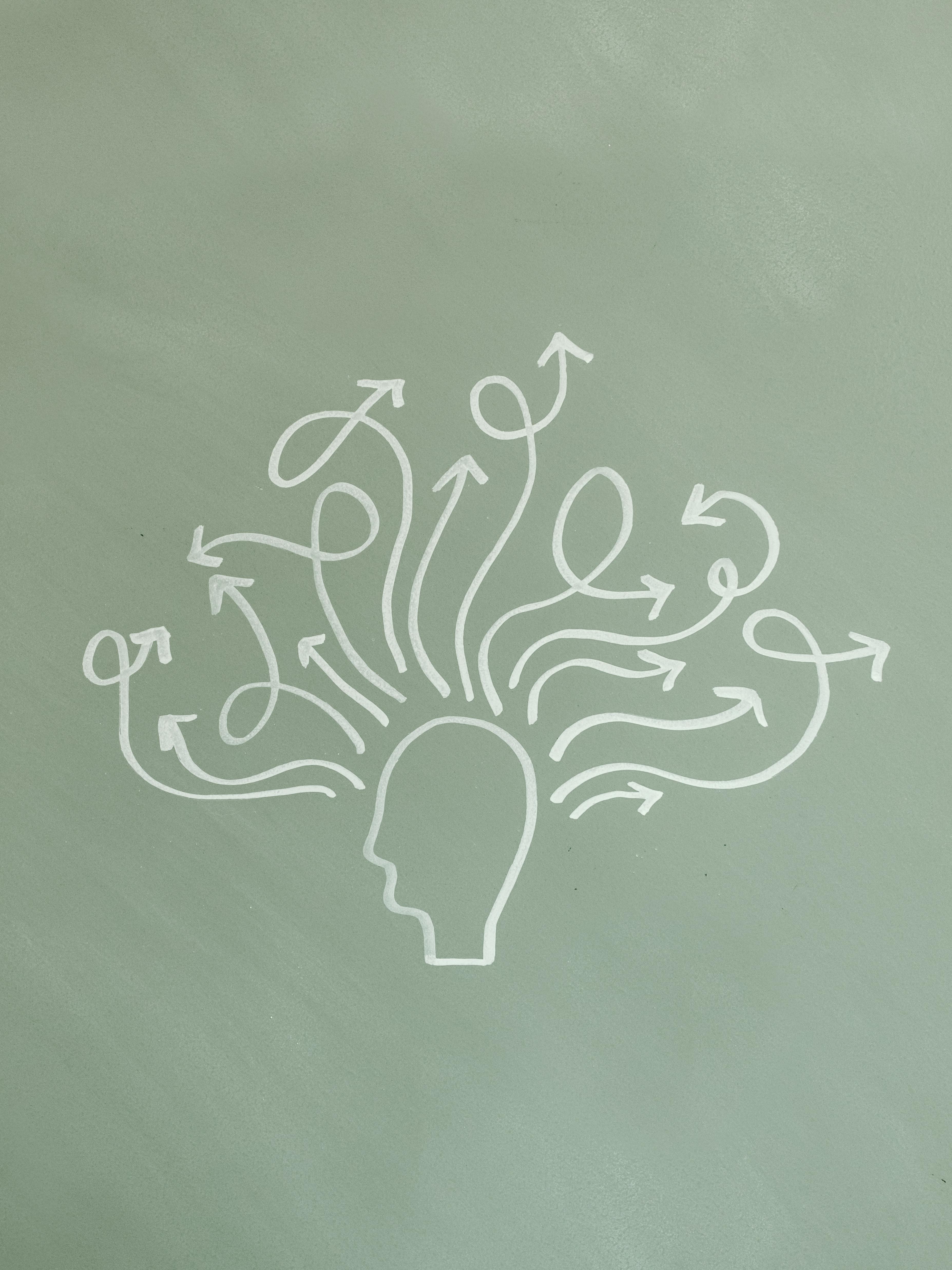 silhouette of a head with lots of arrows coming out of it