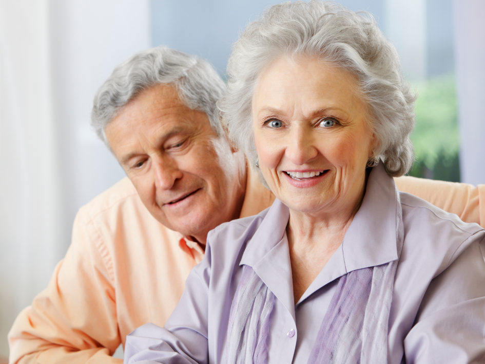 Older adults using a tablet together.