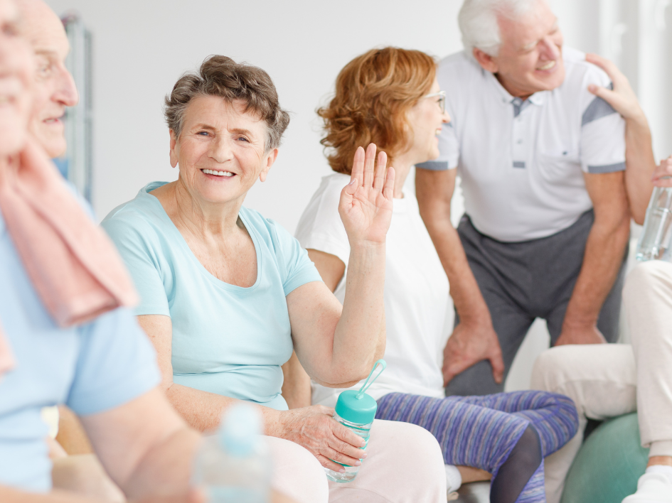 Smiling older adults socializing and exercising.