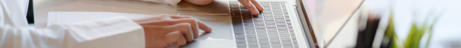 photograph of a person using a laptop