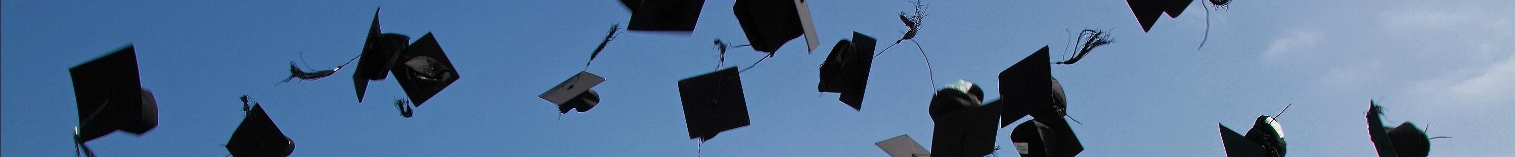 image of graduation caps being thrown into the sky